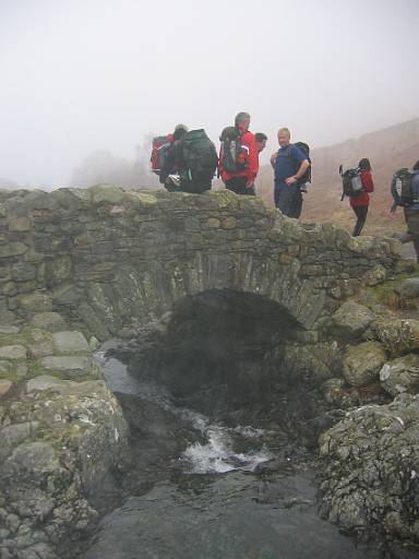 16_18-1.jpg - Ashness Bridge. We've walked through Watendlath and along Watendlath Beck. Both made interesting by swirling mist - quite a contrast to the heights of Ullscarf. We are debating whether it is worth the effort of climbing Walla Crag in mist.